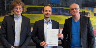 from left: Dean Prof. Schulze Darup, Prof. Bartz holding his certificate of appointment and President Prof. Bayer
