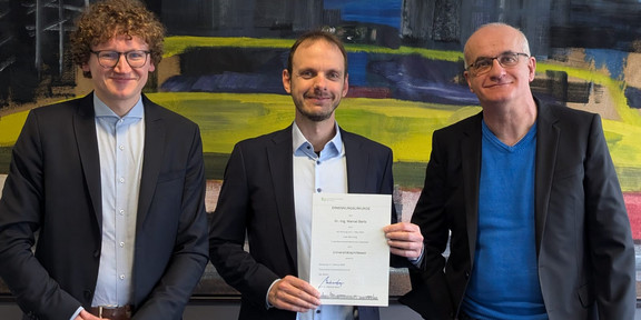 from left: Dean Prof. Schulze Darup, Prof. Bartz holding his certificate of appointment and President Prof. Bayer