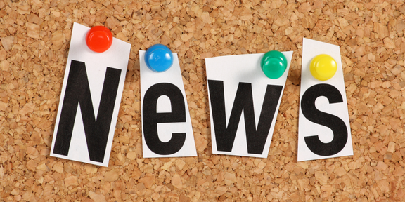  The word “News” is pinned to a bulletin board.
