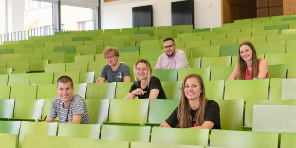 A Group of students in lecture hall A group of students are sitting in a lecture hall.
