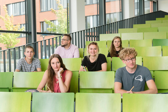 Gruppe Studierender im Hörsaal Eine Gruppe Studierender sitzt in einem Hörsaal.